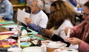 Dravidi Stinnett doing paper crafts with the elderly